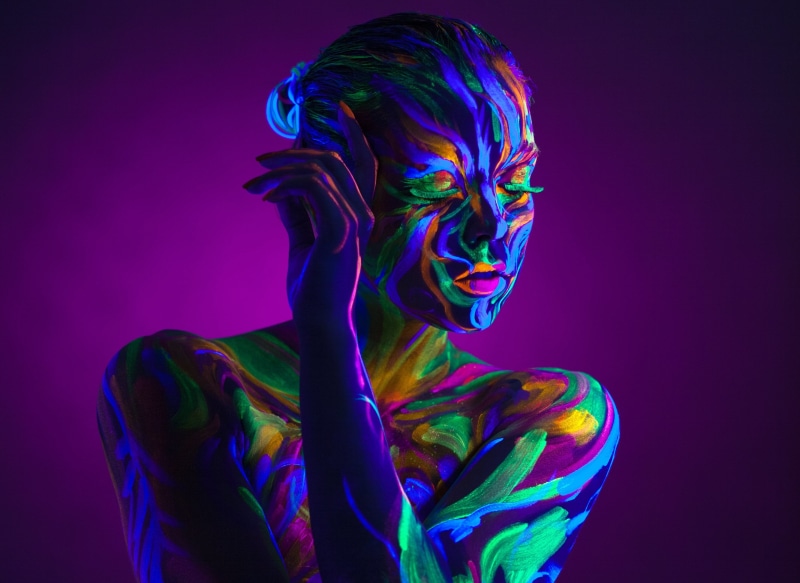 face, vibrant color, one person, adult, young adult, illuminated, purple background, dark, fluorescent light, bright, portrait, multicolored, neon colored