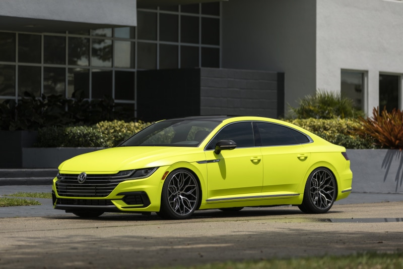 land vehicle, transportation, stationary, building exterior, yellow cars, building, no people, Volkswagen Arteon, parking, motor vehicle, luxury, fluorescent