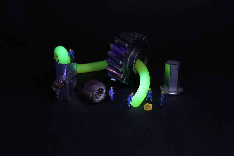 bottle, studio shot, luminescence, technology, technician, glowing, miniature, machine, 5K, workers, still life, transparent, thw, green color, group of objects