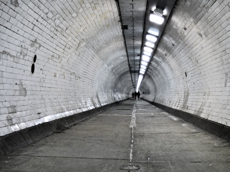 lighting equipment, wall - building feature, urban, direction, real people, public transportation, diminishing perspective, built structure, footpath, historical