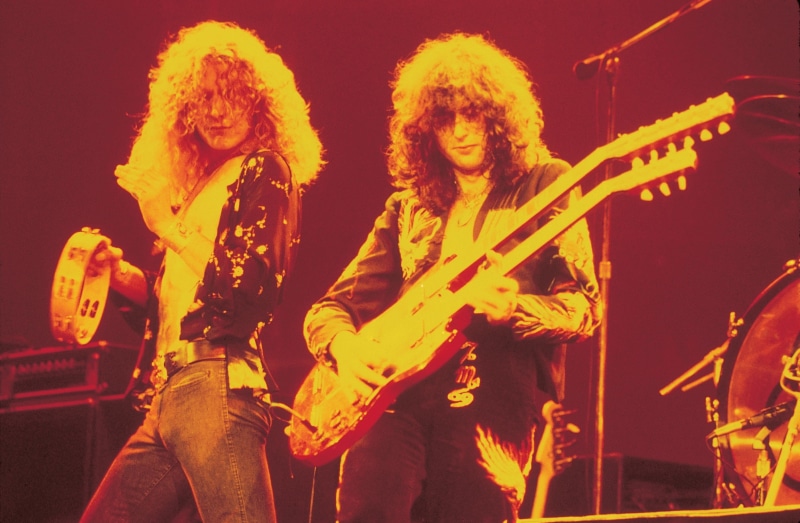 two people, electric, arts culture and entertainment, Led Zeppelin, festival, playing, musical instrument, stage - performance space, guitar, hairstyle