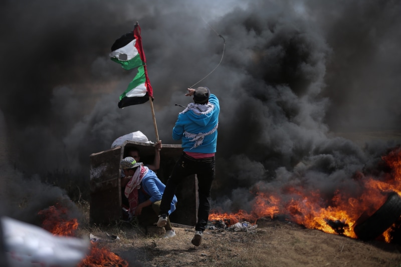nature, real people, smoke - physical structure, standing, full length, burning, holding, flame, strip, sky, gaza, lifestyles, heat - temperature, people