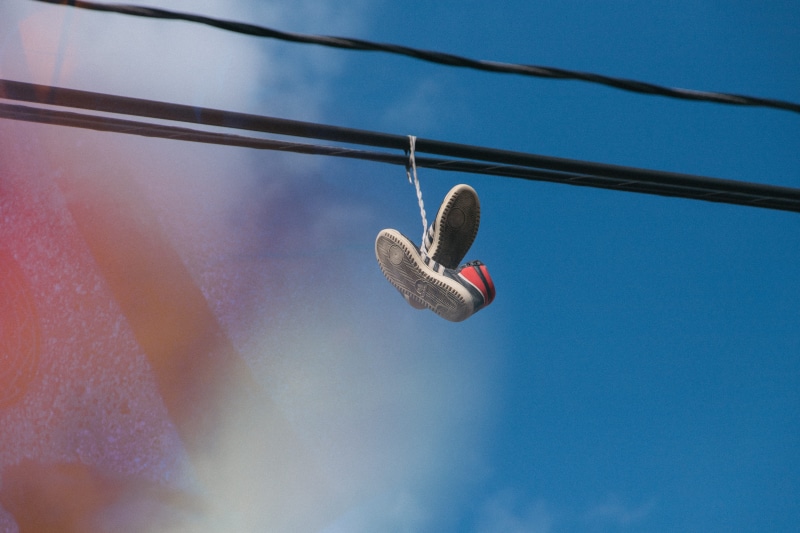 outdoors, shoe, close-up, sunlight, running shoe, street, cable, explore, clear sky, pair, street photography, no people, compatibility, nature, sport