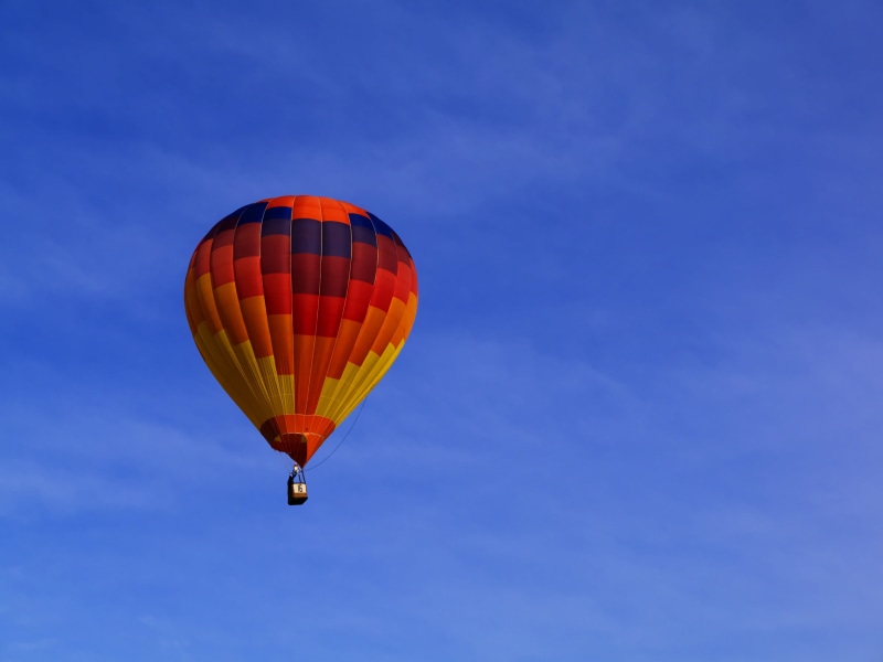 ballooning festival, motion, fly, air, clouds, extreme sports, blue, multi colored, adventure, mode of transportation, sky, outdoors, still, items, nature