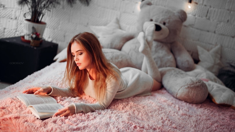 leisure Activity, hairstyle, internet, furniture, arched back, pillow, computer, cozy, straight hair, resting, enjoyment, sweater, young Adult, morning