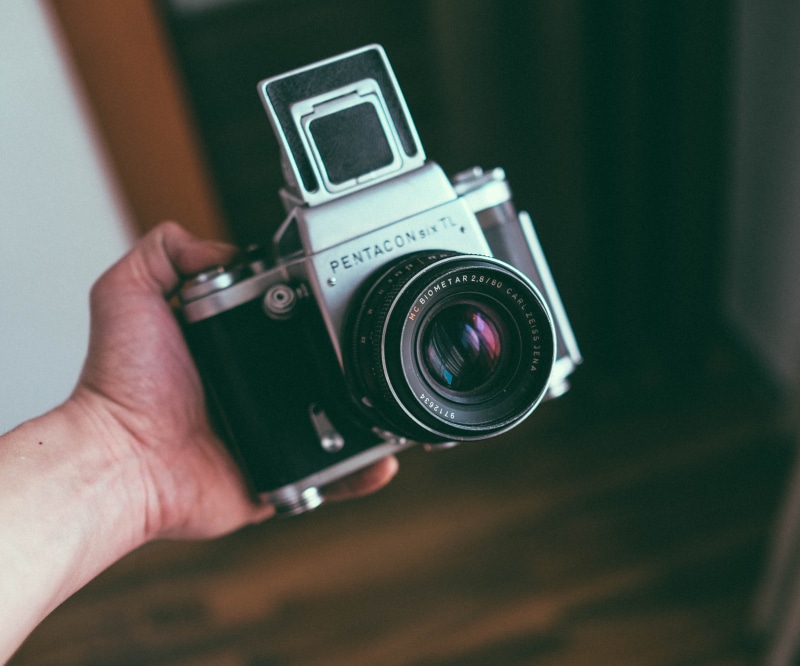 holding, photographing, focus on foreground, lens - optical instrument, indoors, camera, vintage camera, photographer, activity, human hand, photography themes