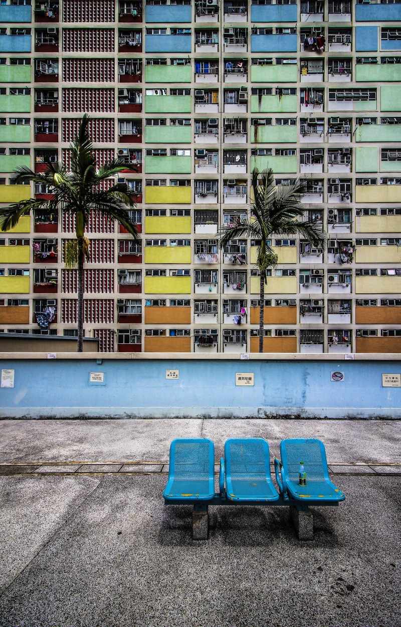 land vehicle, concrete, car, day, plant, tree, outdoors, kowloon, seat, yellow, balcony, building, window, apartment, city, residential district, transportation