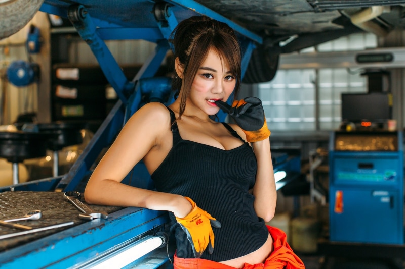 clothing, indoors, front view, lifestyles, garages, holding, young adult, women, brunette, one person, three quarter length, cleavage, looking at viewer