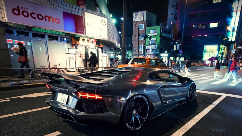 mode of transportation, nightlife, building exterior, illuminated, car, outdoors, night, transportation, city life, lamborghini, coupe, built structure
