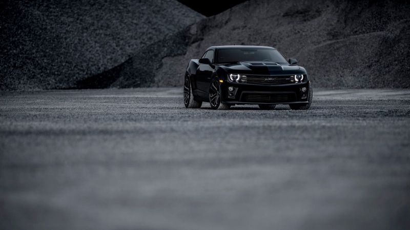 land vehicle, selective focus, mode of transportation, asphalt, car, surface level, road, city, motor vehicle, Chevrolet Camaro, transportation, motion