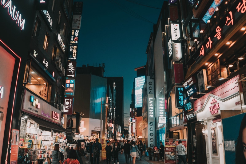 commercial sign, city, 5K, store, incidental people, walking, low angle view, dark, sign, night life, text, group of people, advertisement, building exterior