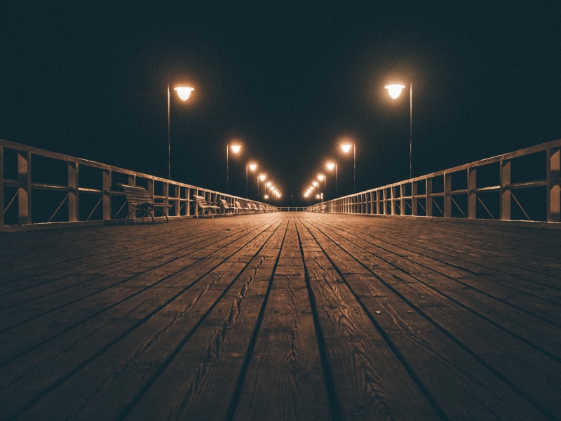 street light, railing, surface level, outdoors, pier, nature, time, diminishing perspective, the way forward, transportation, sky, lighting equipment, footbridge