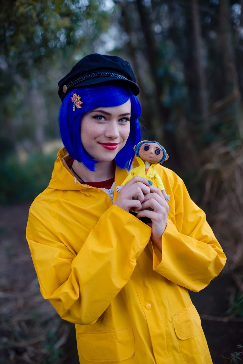 front view, young adult, blue eyes, looking at camera, focus on foreground, yellow jacket, depth of field, red lipstick, raincoat, looking at viewer, one person