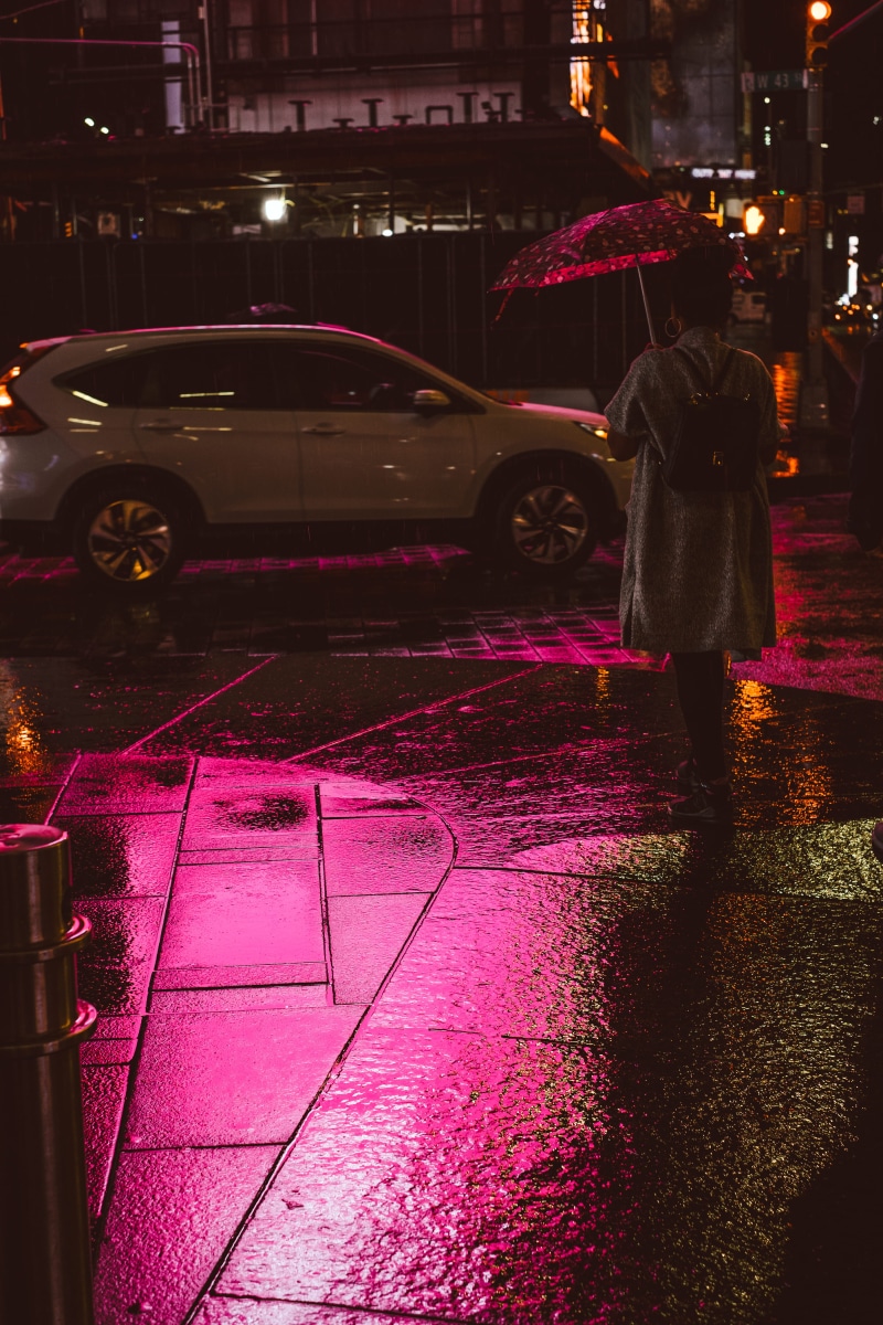one person, road, open, built structure, urban, land vehicle, real people, building exterior, path, walking, nighttime, night, spraying, sidewalk, nightlife
