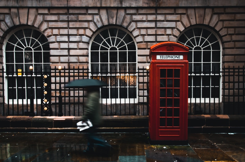 beside, woman, outdoors, front, arch, red, brown, real people, gate, metal, brick, book, photography, window, text, near, london, lapse, one person, day