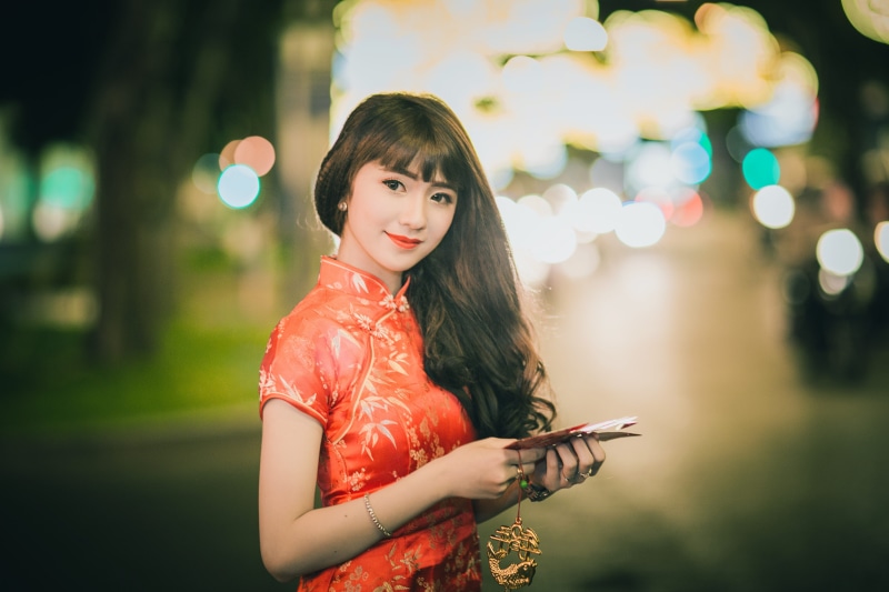 holding, traditional wear, fashion, style, smiling, joy, photoshoot, woman, portrait, young adult, person, pretty, blur, dress, red, looking at camera