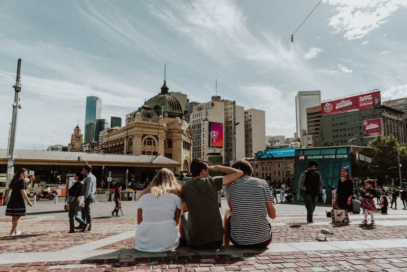 sky, city life, outdoors, building, building exterior, aesthetic, women, front, cloud - sky, lifestyles, street, back, stair, sitting, tourists, day, skyscraper