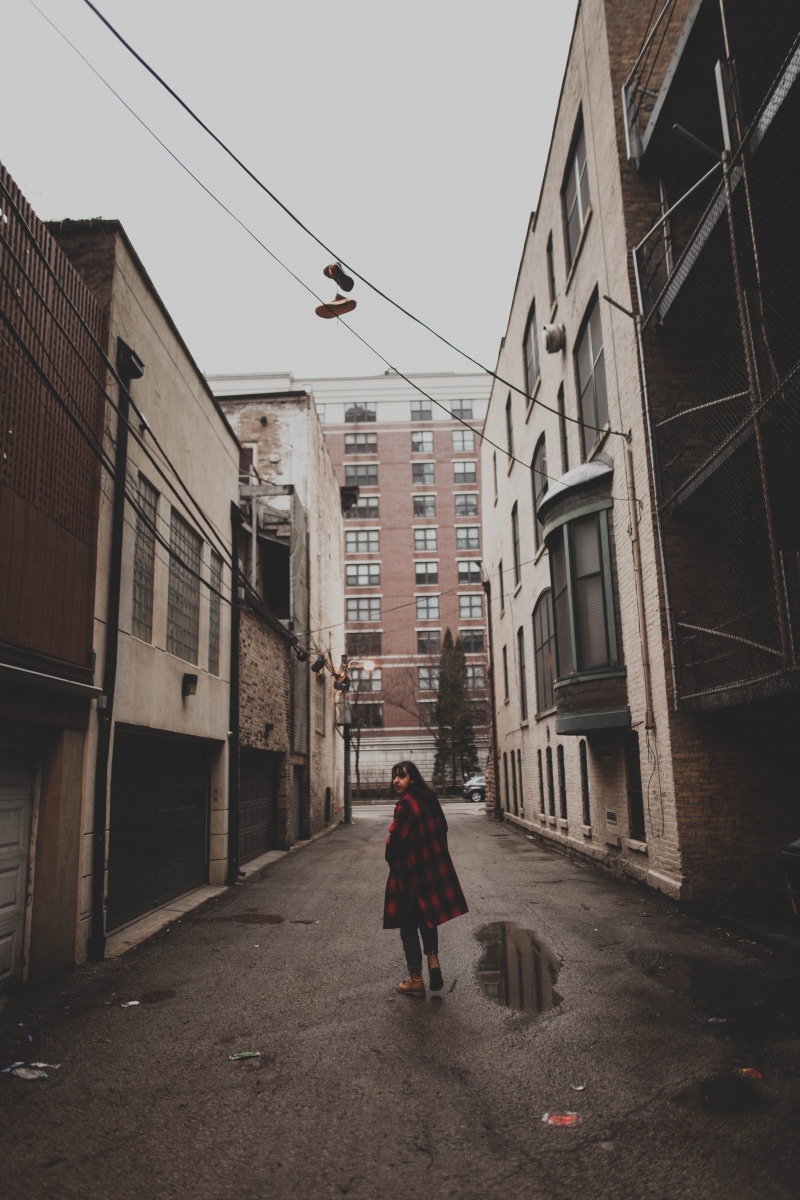 adults only, one person, sky, women, shoe, store, middle, day, wire, people, street, walking, establishment, standing, lifestyles, road, built structure