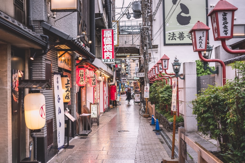 signage, pavement, osaka, text, person, street, script, near, travel, building exterior, house, city, 5K, direction, lighting equipment, built structure