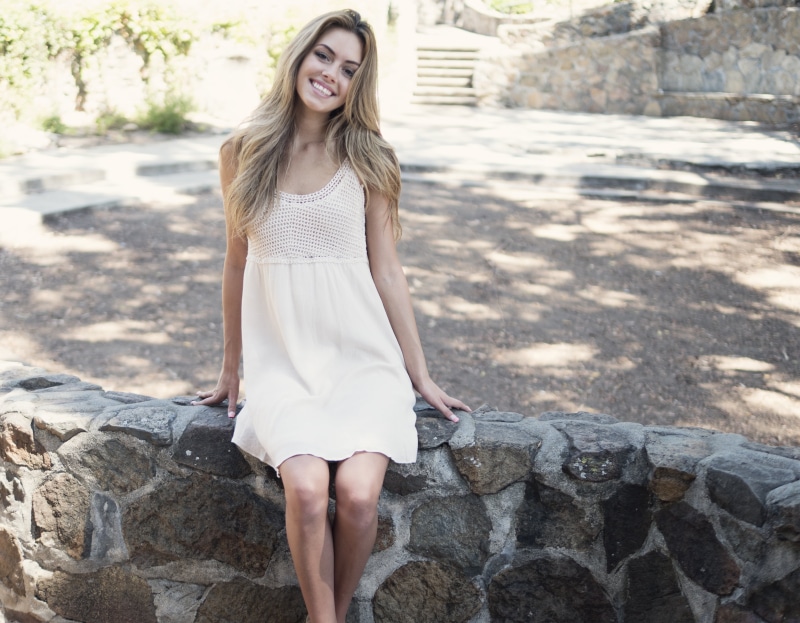 fashion, leisure activity, sitting, smile, woman smile, outdoors, rock, 4K, young women, face, happiness, front view, looking at camera, attractive, long hair