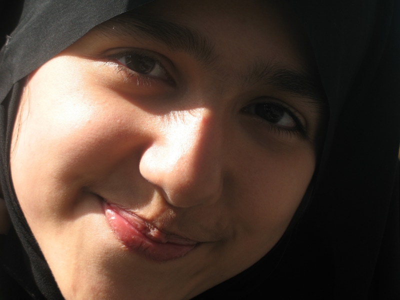 women, religion, day light, headshot, turkish Ethnicity, cute, indoors, smiling, contemplation, front view, headscarf, only Women, one Person, black background