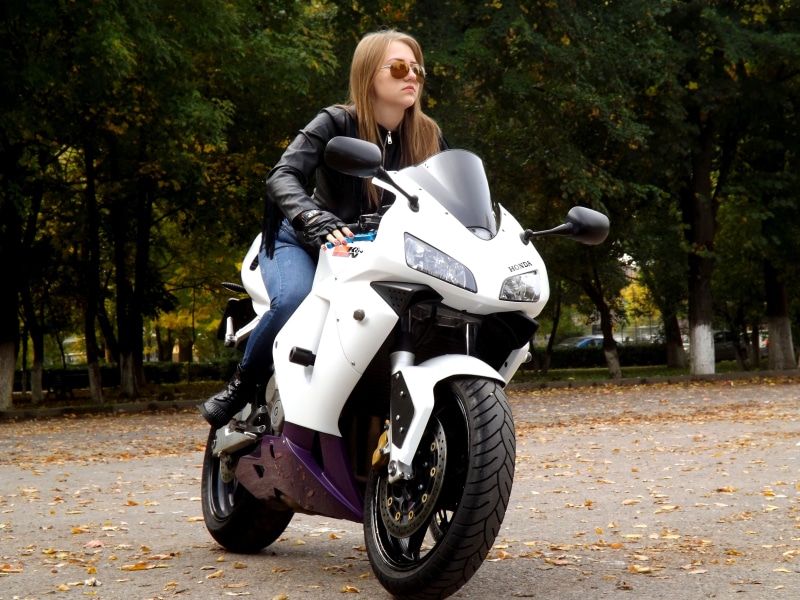 sitting, road, crash helmet, land vehicle, driving, leisure activity, biker, real people, lifestyles, motorcycle, woman, leather jacket, one Person, girl