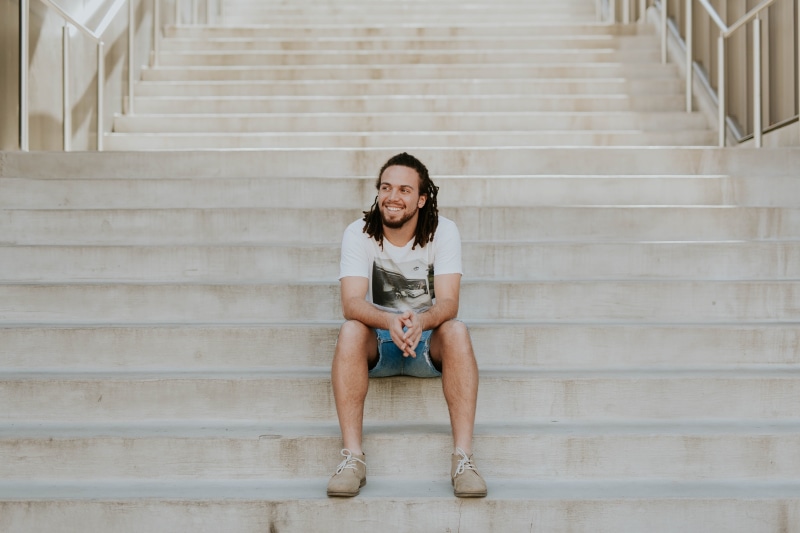 young adult, lifestyles, looking at camera, women, man, relaxation, stairs, emotion, architecture, adult, leisure activity, steps and staircases, shorts