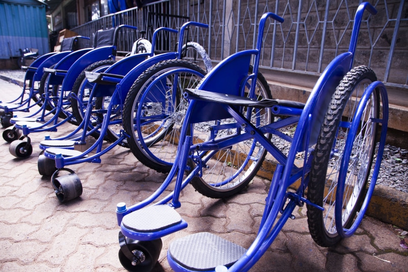 wheel, transportation system, metal, wheel chair, steel, blue, wheelchairs, travel, wheels, chair, disability, absence, street, no people, business, disabled