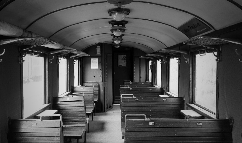 grayscale, arch, transportation system, train, direction, no people, inside, the way forward, lighting equipment, staircase, architectural column, subway system
