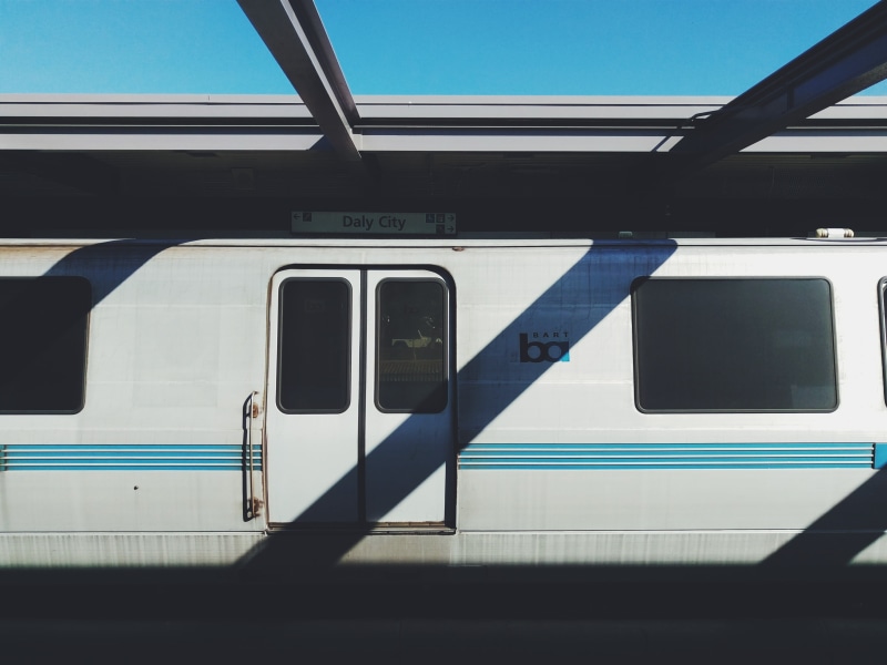 public transportation, rail transportation, built structure, teal, outdoors, photography, mode of transportation, train - vehicle, sunlight, window, track