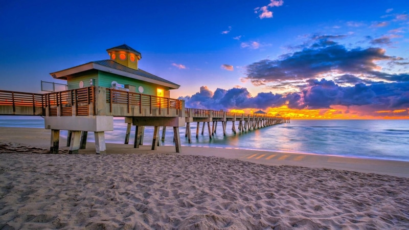 sunset, sand, no people, tranquility, beauty in nature, juno beach, fishing pier, united states, cloud - sky, tourism, pier, vacation, scenics - nature
