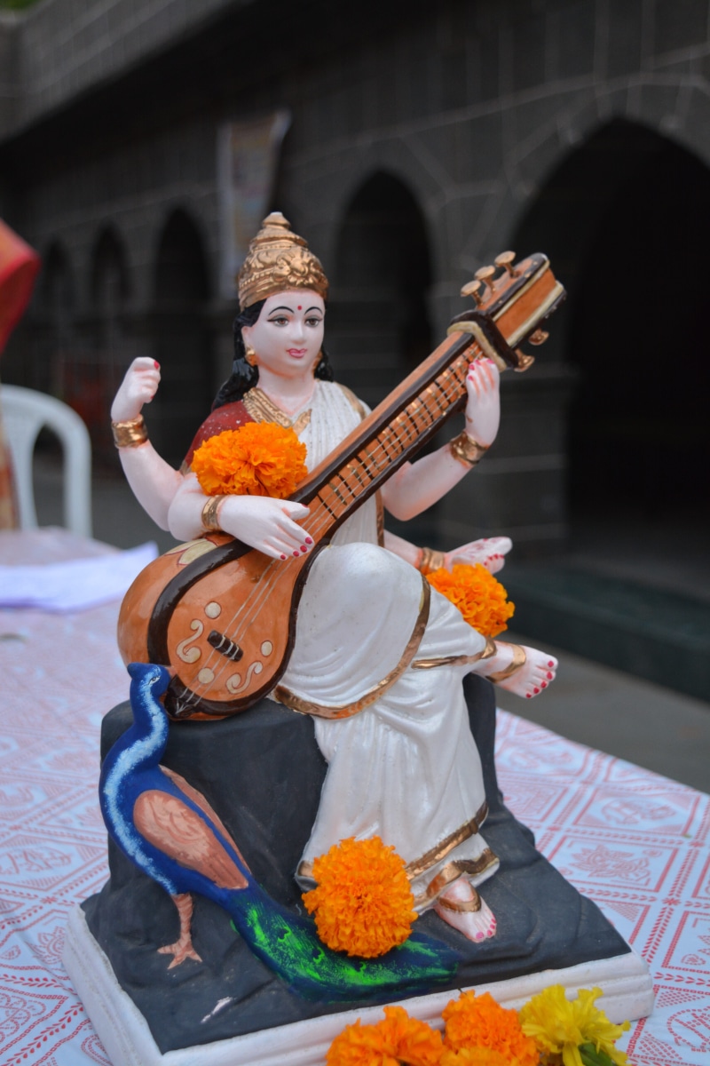 built structure, traditional, knowledge, mythological, clothing, real people, flower, city, worship, religious, hinduism, architecture, focus on foreground