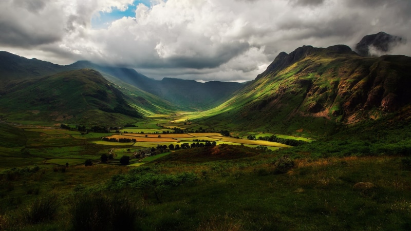non-urban scene, mountain range, environment, cloud - sky, mountain, tranquility, field, idyllic, green color, tranquil scene, grass, nature, land, plant