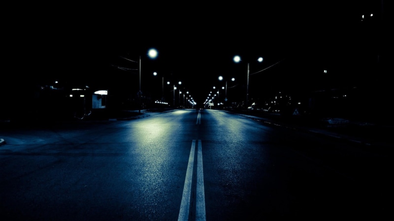 road marking, diminishing perspective, direction, road, black, land vehicle, lighting equipment, motion, architecture, symbol, built structure, street