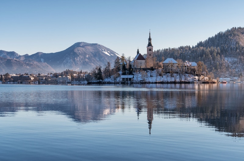 church, Slovenia, no people, tree, religion, house, landscape, sky, trees, Lake Bled, architecture, outdoors, forest, island, hill, building exterior, snowcapped mountain