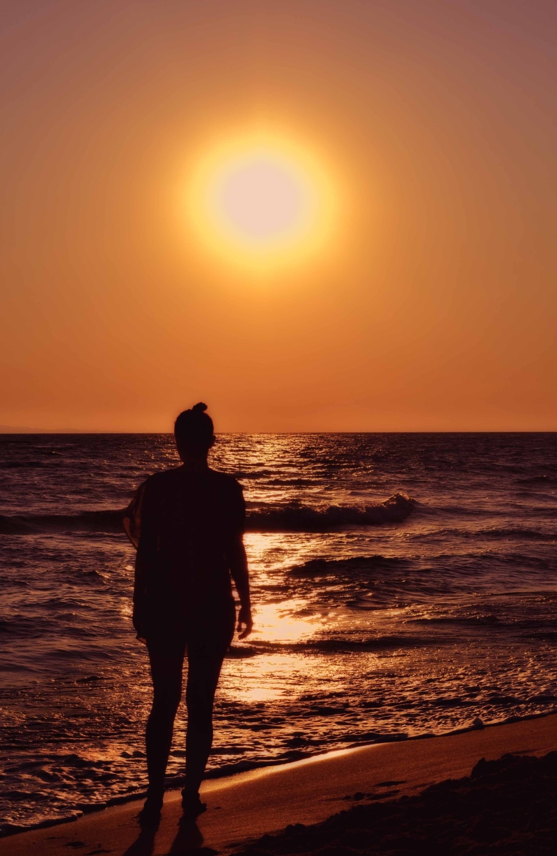 sun, lifestyles, back Lit, shore, water, standing, orange, pure, silhouette, sea, beauty in nature, horizon, fire, outdoors, one person, sunset beach, attractive