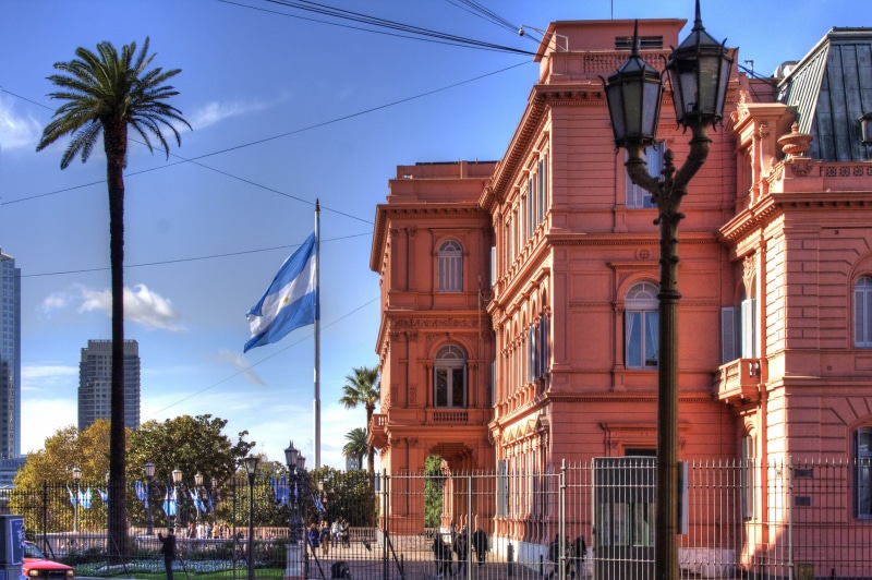 sky, city, the past, famous Place, built structure, transportation, tropical climate, plant, capital, urban Scene, casa rosada, government, palm tree, landmark