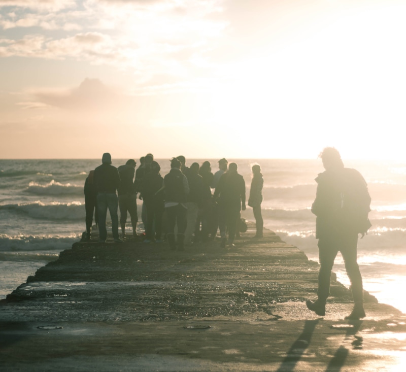 boardwalk, sea, adults only, day, standing, youth, person, real people, horizon over water, vacations, beach, back Lit, walking, time, women, group, group Of People