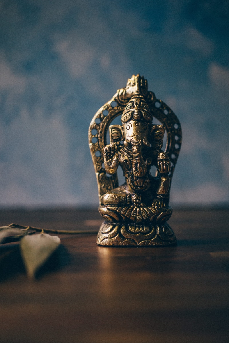 statue, indoors, surface level, silver colored, ganesha, ganesh, antique, selective focus, 4K, art and craft, ornate, human representation, representation