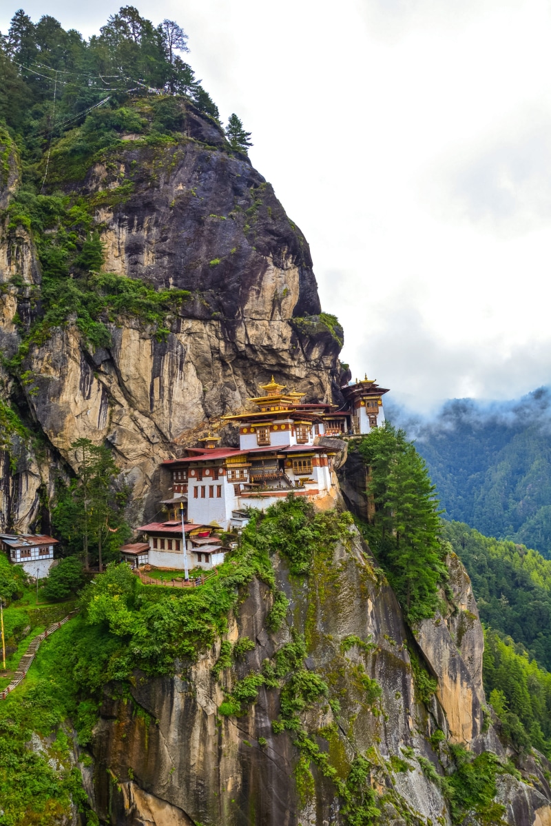 architecture, tigers nest, buddhism, plant, built structure, building exterior, taktshang, sky, rock, history, formation, landscape, mountain range, paro