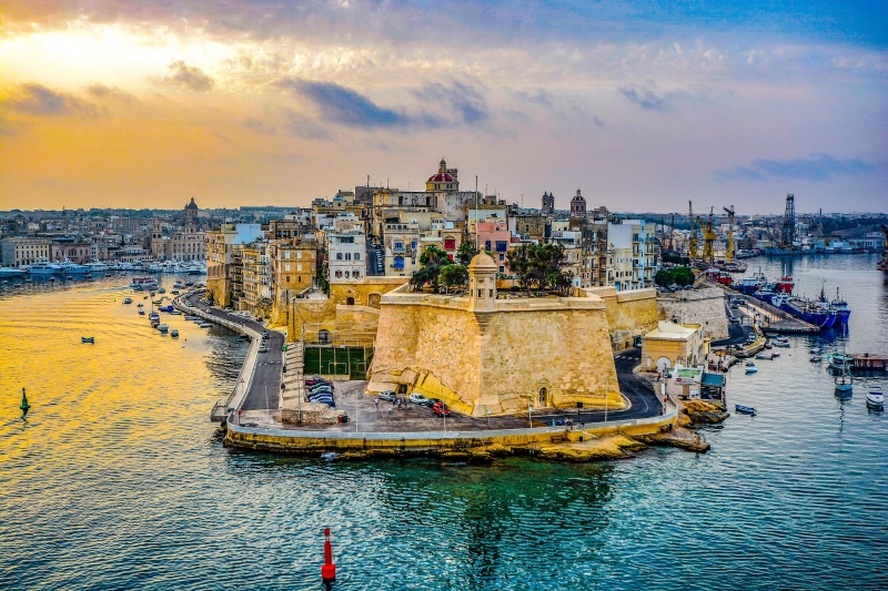 pier, harbor, built structure, incidental people, water, travel, sunset, sea, cloud - sky, passenger craft, building exterior, Port, Malta, river, transportation