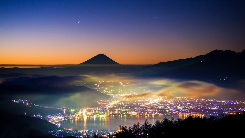 mountain peak, painting, skyline, illuminated, environment, beauty in nature, mist, architecture, lake, landscape, stars, silhouette, outdoors, city, long exposure