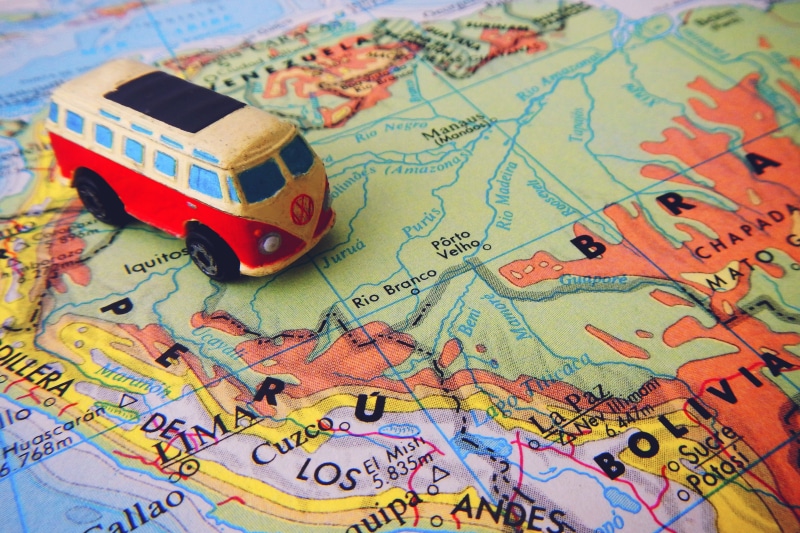 selective focus, antique, guidance, van, western script, car, indoors, close-up, world map, focus on foreground, multi colored, map, journey