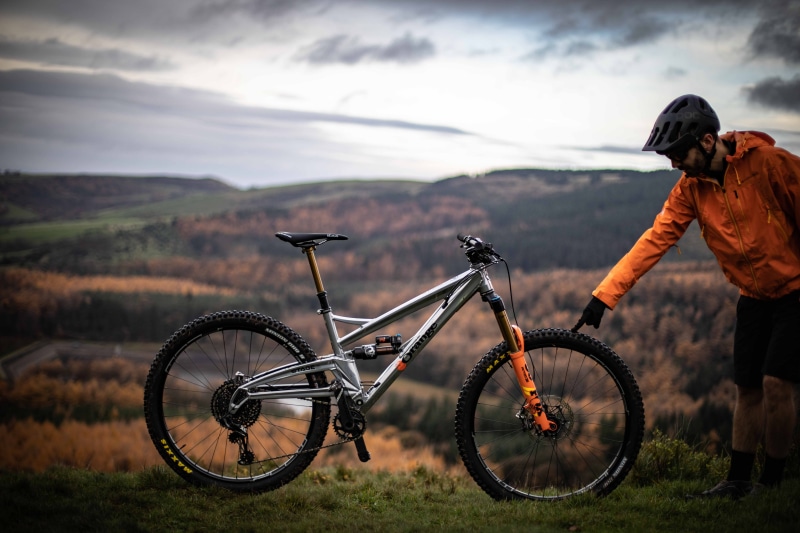 transportation, apparel, suspension, riding, full length, bmx, vehicle, person, clothing, mountain, nature, leisure activities, gray, mode of transportation