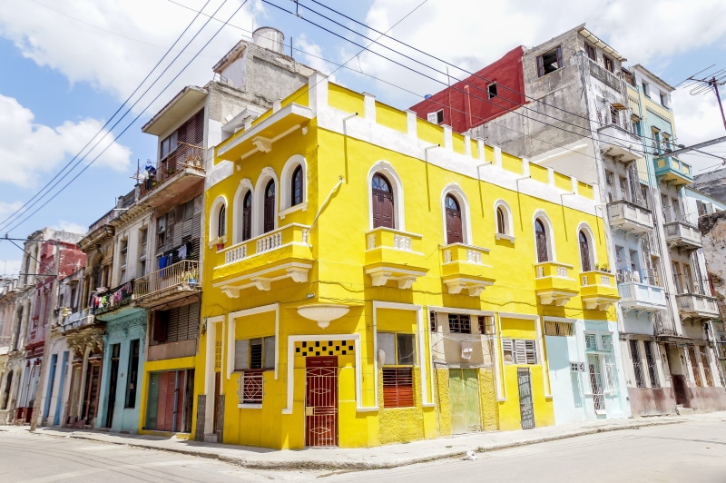 residential district, destination, outdoors, window, built structure, yellow, wanderlust, cable, cloud - sky, nature, cuba, day, building, havana, road
