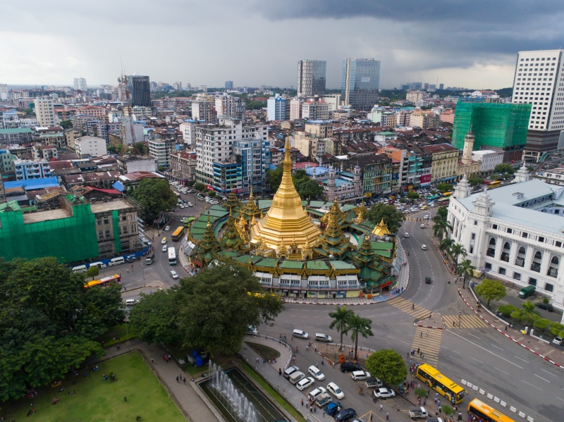 building exterior, belief, sule pagoda, city street, building, car, aerial, architecture, road, nature, outdoors, cityscape, landmark, motor vehicle, pagoda