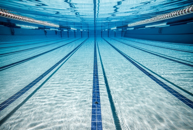 absence, water, swimming pool, swimming lane marker, flooring, blue, empty, built structure, station, day, pool, ceiling, motion, architecture, underwater