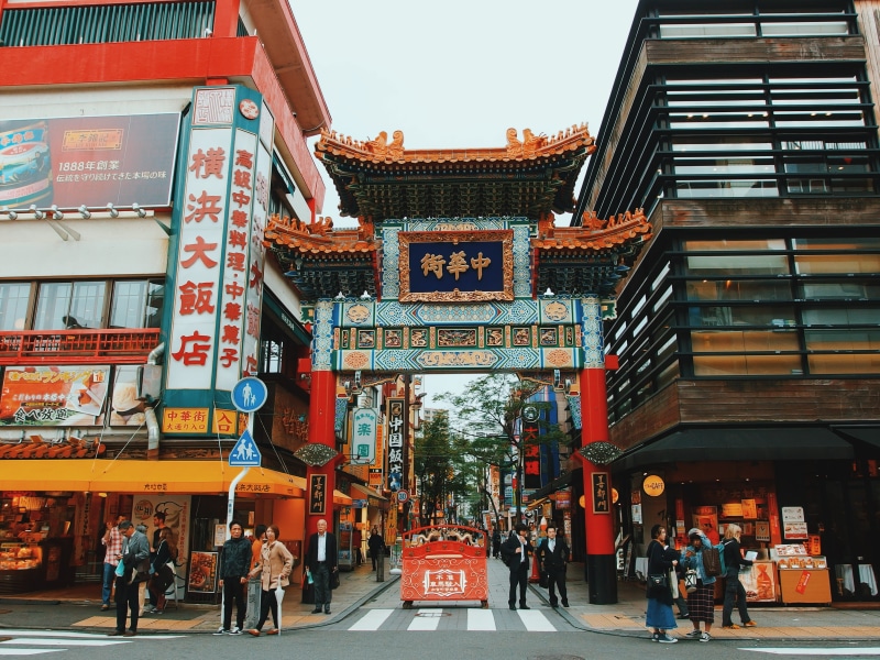front, women, buildings, pedestrian, japan, people, communication, script, building exterior, beside, text, asium, daytime, built structure, walking, gate