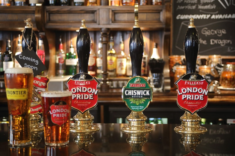 no people, small business, beer, focus on foreground, pub, retail display, sign, arrangement, england, text, retail, for sale, business, still life, large group of objects