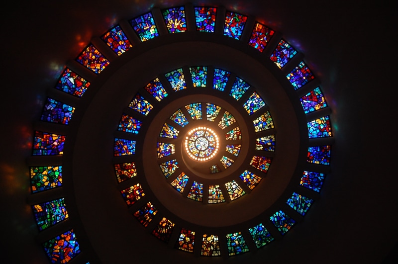 rainbow, low angle view, floral pattern, building, glass, stain, travel destinations, color, pattern, indoors, directly below, chapel, architecture, spiritual